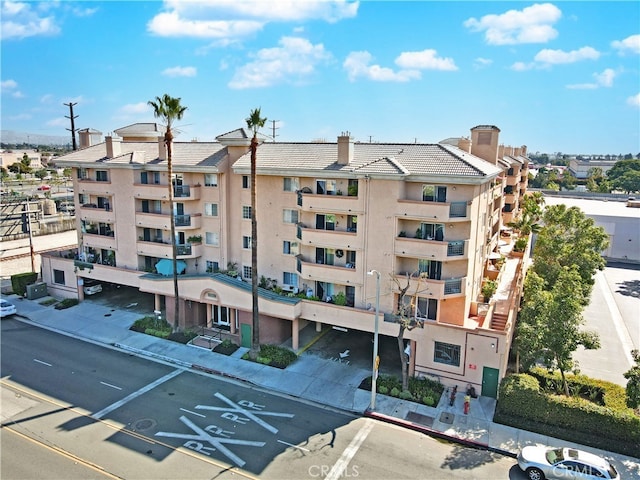 view of building exterior with uncovered parking