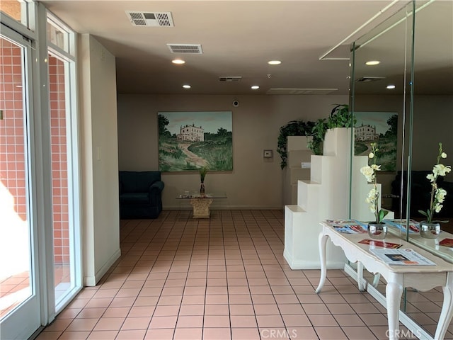 corridor with light tile patterned floors, visible vents, and recessed lighting