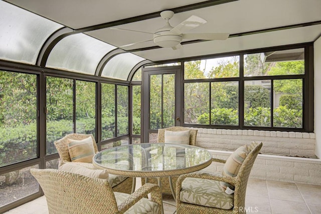 sunroom featuring outdoor dining space and a ceiling fan
