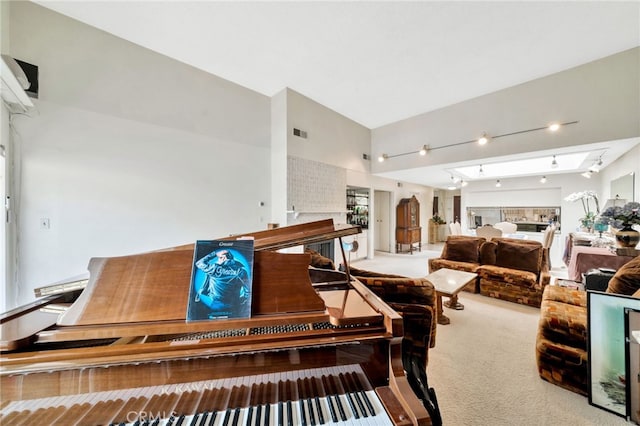 interior space with visible vents, rail lighting, and high vaulted ceiling