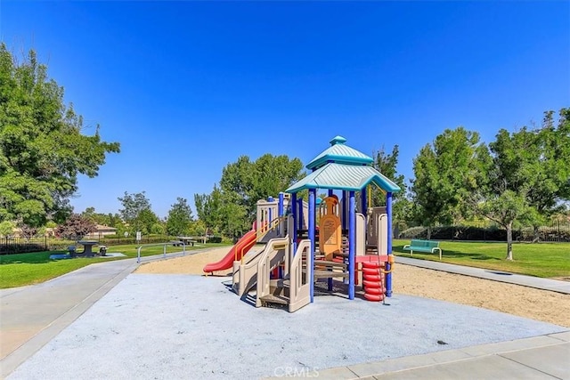 communal playground featuring a lawn