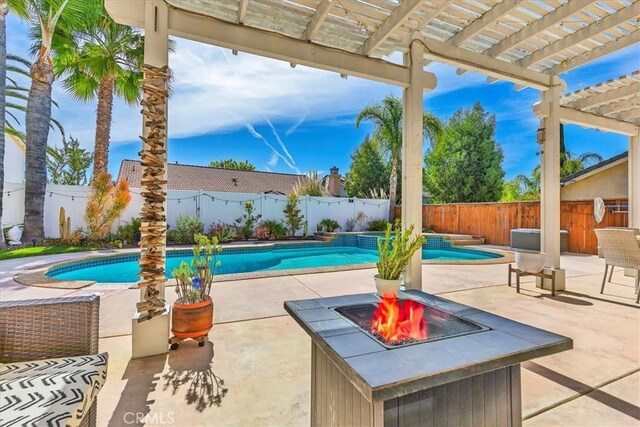view of swimming pool with a pergola, a fenced in pool, a fire pit, and a fenced backyard