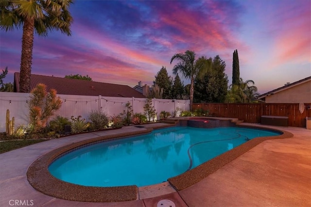 view of swimming pool featuring a fenced backyard, a patio area, and a pool with connected hot tub