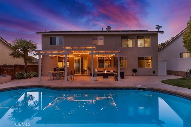 back of property at dusk featuring an outdoor living space, a patio, fence, a pergola, and stucco siding