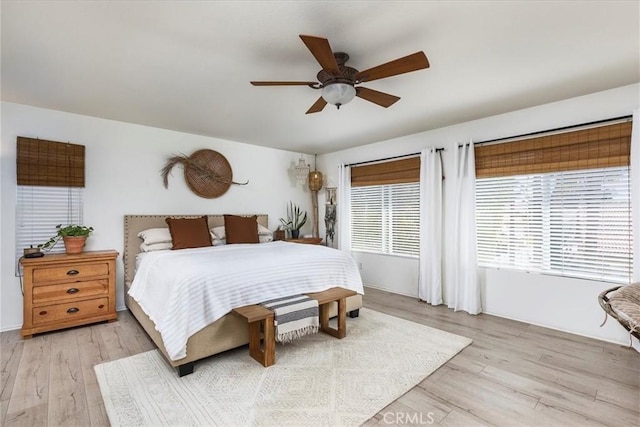 bedroom with light wood-style floors and ceiling fan