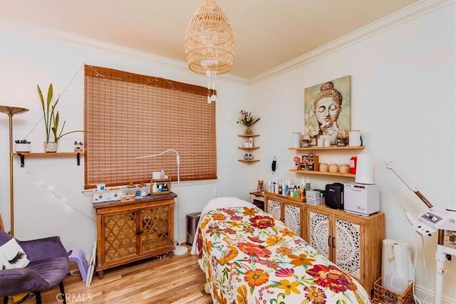 bedroom featuring ornamental molding and wood finished floors