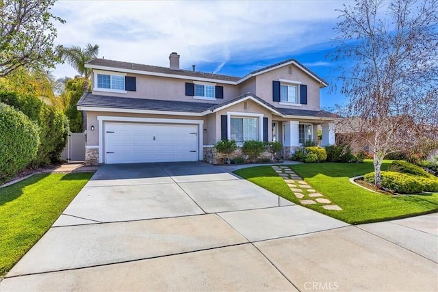 traditional-style house with a front yard, a garage, concrete driveway, stone siding, and stucco siding