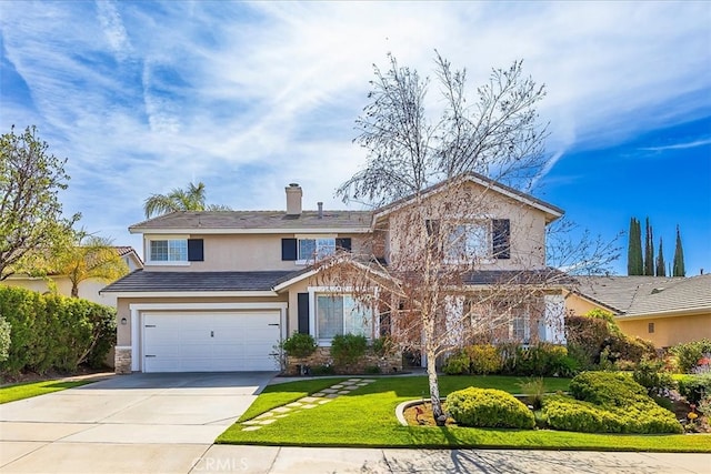 traditional-style house with a garage, a front yard, stucco siding, a chimney, and driveway