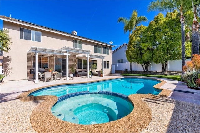 view of pool with a pergola, a pool with connected hot tub, fence, and a patio area