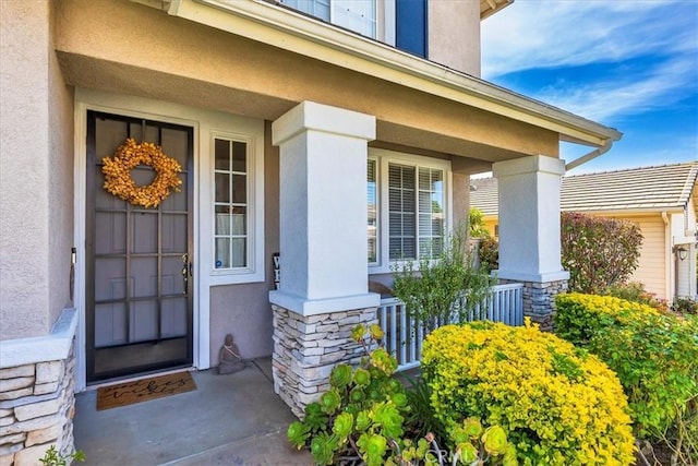 41028 Promenade Chardonnay Hls, Temecula, CA 92591 - doorway to property with stone siding, covered porch, and stucco siding