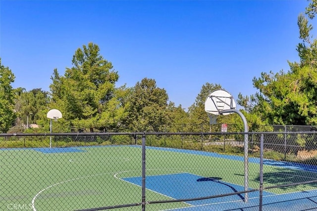 view of basketball court featuring fence and community basketball court