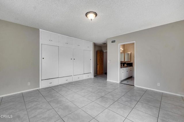 1530 Calle Portada, Camarillo, CA 93010 - unfurnished bedroom featuring light tile patterned flooring, a textured ceiling, and visible vents