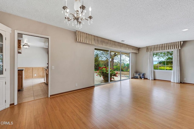 1530 Calle Portada, Camarillo, CA 93010 - unfurnished room with a chandelier, a textured ceiling, and light wood finished floors
