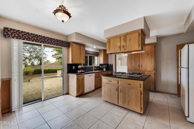 1530 Calle Portada, Camarillo, CA 93010 - kitchen featuring a sink, tasteful backsplash, light tile patterned flooring, dark countertops, and white appliances