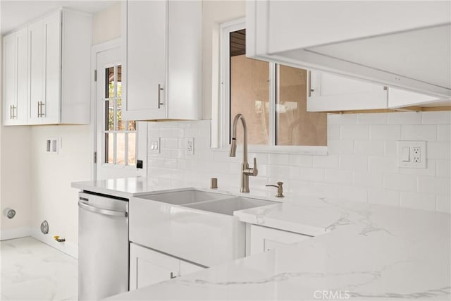 kitchen with light stone countertops, decorative backsplash, dishwasher, and white cabinetry