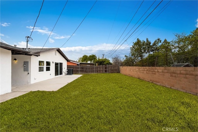 view of yard with central AC, a patio, and a fenced backyard