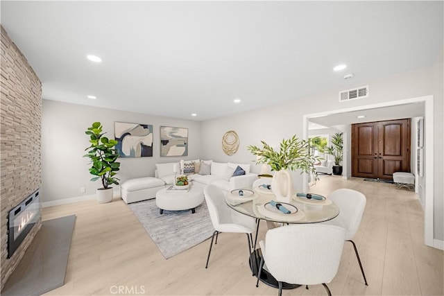 12 Whitewood Way, Irvine, CA 92612 - dining area with a fireplace, recessed lighting, light wood-style flooring, and visible vents