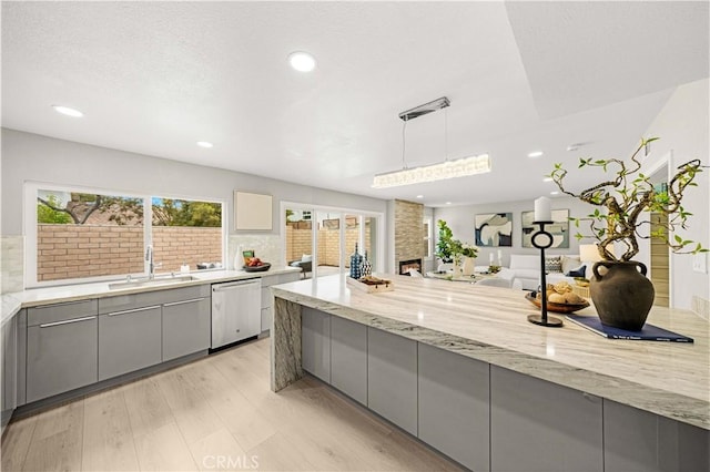 12 Whitewood Way, Irvine, CA 92612 - kitchen with gray cabinets, light stone countertops, dishwasher, a sink, and recessed lighting