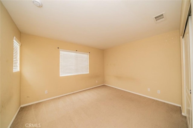 3882 Strand Way, Perris, CA 92571 - unfurnished bedroom featuring light carpet, baseboards, and a closet