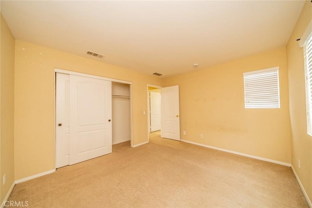 3882 Strand Way, Perris, CA 92571 - unfurnished bedroom featuring light colored carpet, a closet, and baseboards