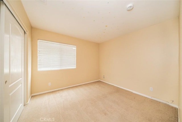 3882 Strand Way, Perris, CA 92571 - unfurnished bedroom featuring light carpet, baseboards, and a closet