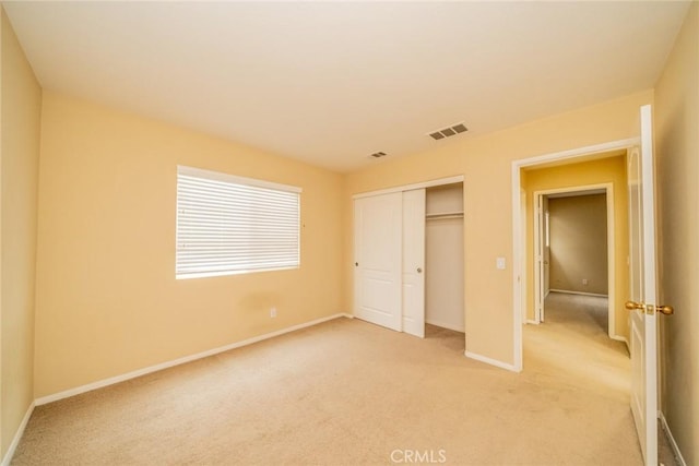 3882 Strand Way, Perris, CA 92571 - unfurnished bedroom with light carpet, baseboards, and a closet