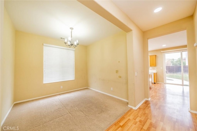 3882 Strand Way, Perris, CA 92571 - unfurnished room with a chandelier, baseboards, light wood-type flooring, and recessed lighting