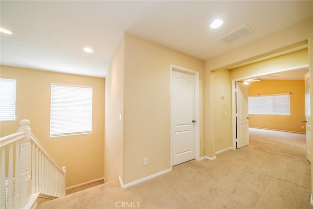 3882 Strand Way, Perris, CA 92571 - corridor with an upstairs landing, carpet, baseboards, recessed lighting, and plenty of natural light