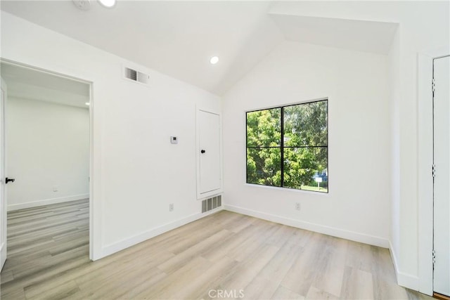 7314 Quill Dr Unit 155, Downey, CA 90242 - empty room with vaulted ceiling, light wood-type flooring, visible vents, and baseboards