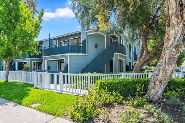 7314 Quill Dr Unit 155, Downey, CA 90242 - back of house featuring a yard, a balcony, and fence private yard