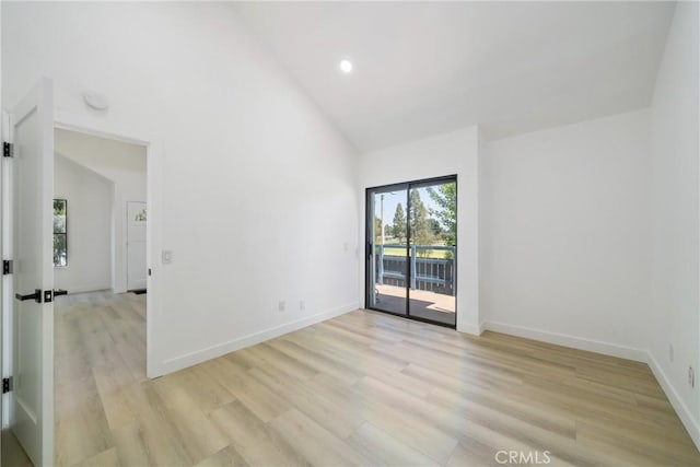7314 Quill Dr Unit 155, Downey, CA 90242 - empty room with light wood finished floors, baseboards, recessed lighting, and high vaulted ceiling