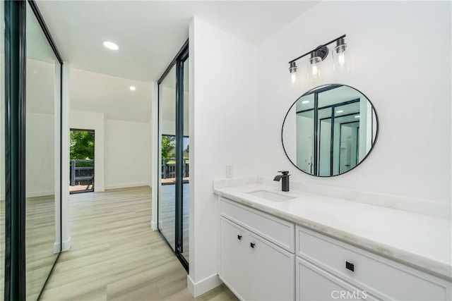 7314 Quill Dr Unit 155, Downey, CA 90242 - bathroom with baseboards, wood finished floors, vanity, and recessed lighting