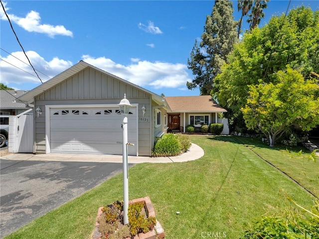 ranch-style house with a front yard, a garage, driveway, and board and batten siding