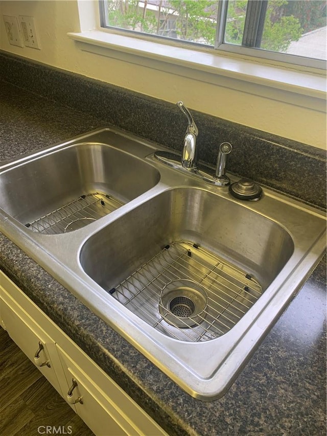 61 Calle Cadiz Unit Q, Laguna Woods, CA 92530 - kitchen view of dark countertops and dark wood-style floors
