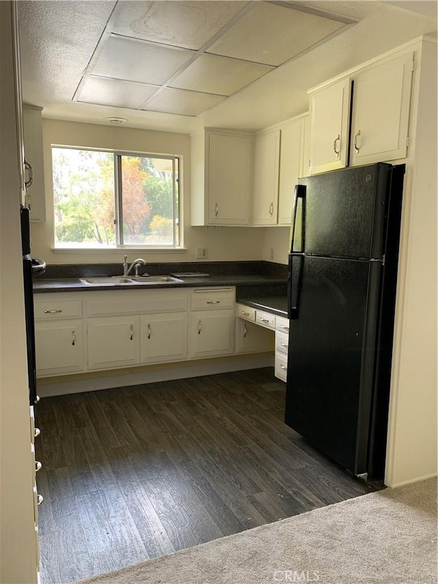 61 Calle Cadiz Unit Q, Laguna Woods, CA 92530 - kitchen featuring freestanding refrigerator, a sink, dark countertops, and dark wood-style floors