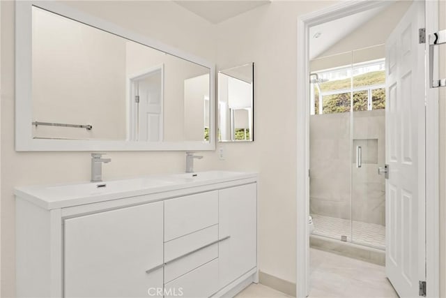 2122 Via Aguila, San Clemente, CA 92673 - bathroom with double vanity, vaulted ceiling, a shower stall, and a sink