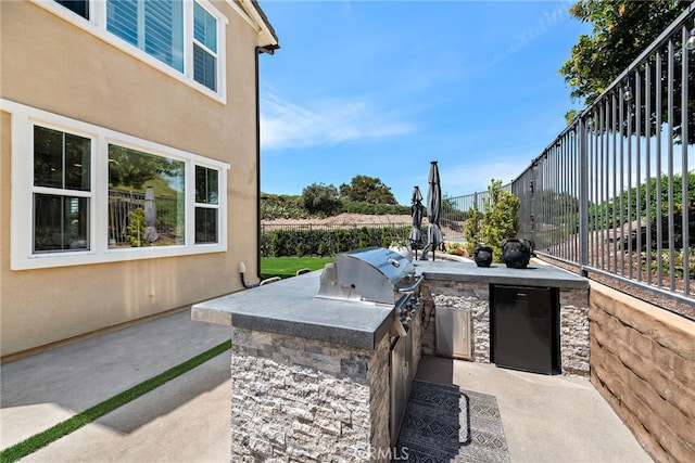 view of patio with area for grilling and fence