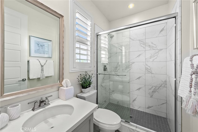 bathroom with a stall shower, a wealth of natural light, vanity, and toilet