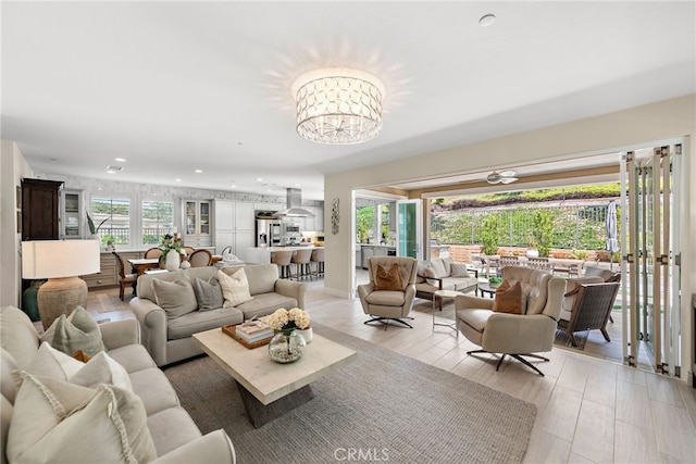 living area with light wood-type flooring, a chandelier, and recessed lighting