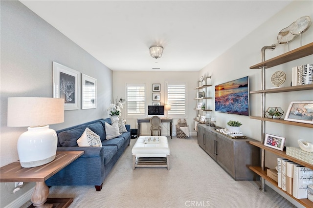 living area featuring light carpet