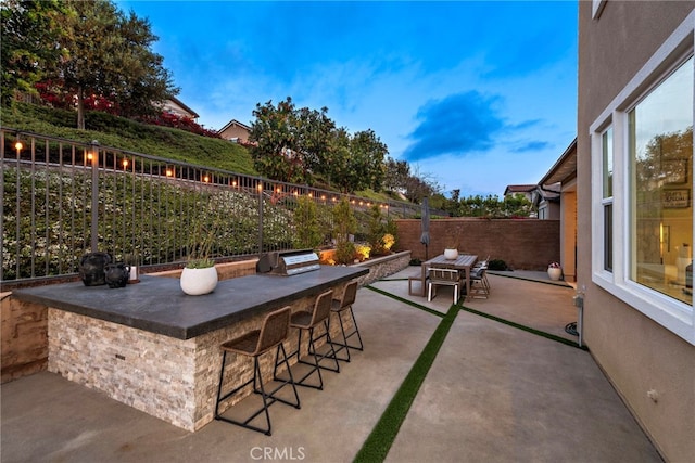 view of patio featuring a fenced backyard and outdoor dry bar