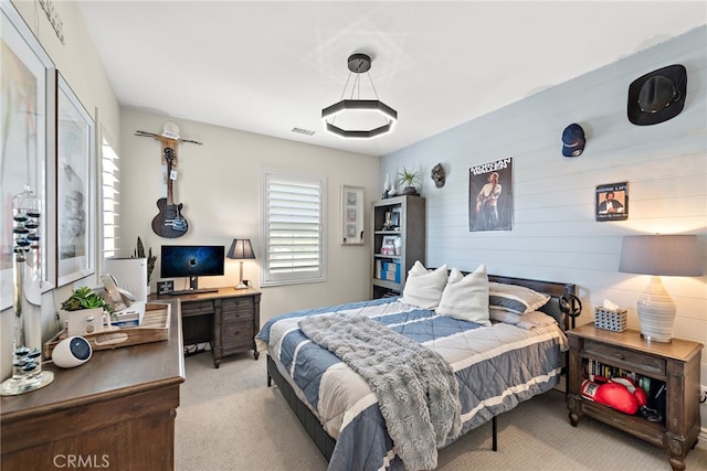 carpeted bedroom featuring visible vents