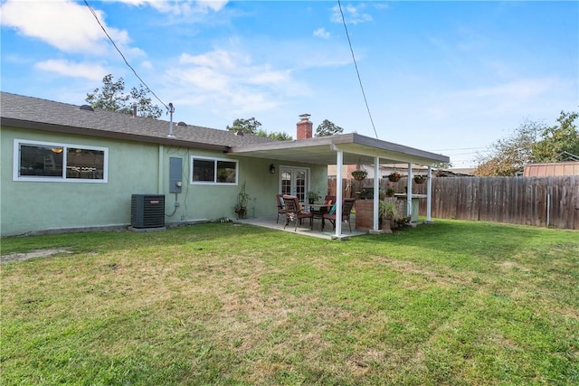 back of house with fence, a patio, stucco siding, a chimney, and central AC unit