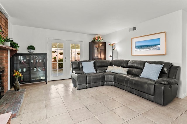 living area featuring light tile patterned flooring, visible vents, and french doors