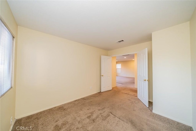 14051 Mare Ln, Victorville, CA 92394 - unfurnished room featuring light colored carpet and plenty of natural light