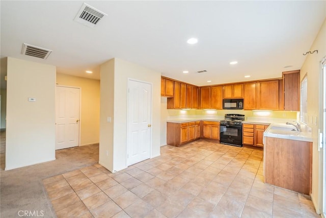 14051 Mare Ln, Victorville, CA 92394 - kitchen featuring black appliances, light countertops, recessed lighting, and brown cabinets