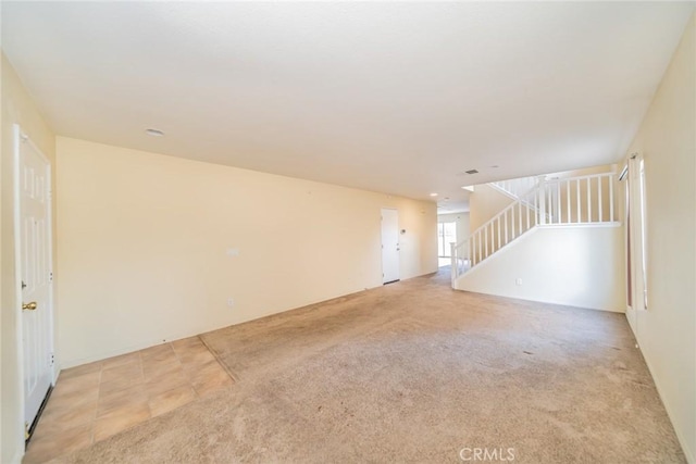 14051 Mare Ln, Victorville, CA 92394 - spare room featuring stairway and light colored carpet