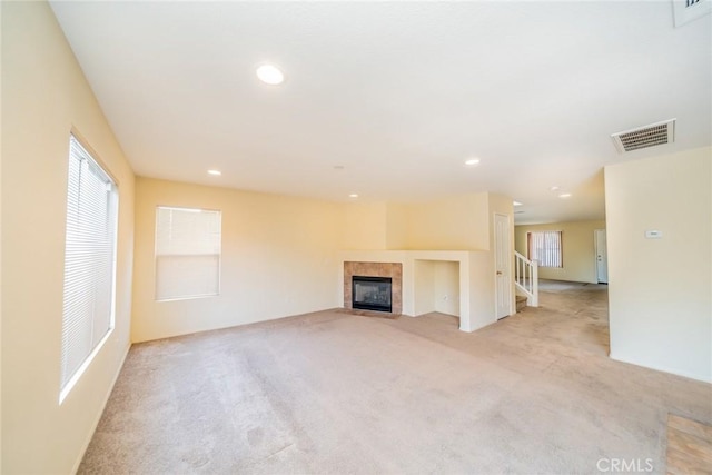 14051 Mare Ln, Victorville, CA 92394 - unfurnished living room with light colored carpet, plenty of natural light, a fireplace, recessed lighting, and stairway
