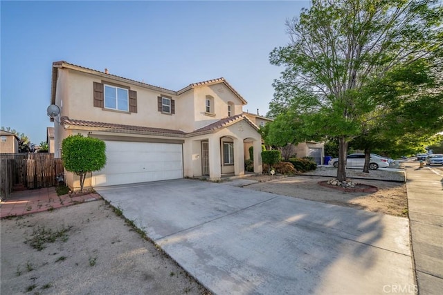 14051 Mare Ln, Victorville, CA 92394 - mediterranean / spanish-style home with stucco siding, concrete driveway, an attached garage, and a tile roof