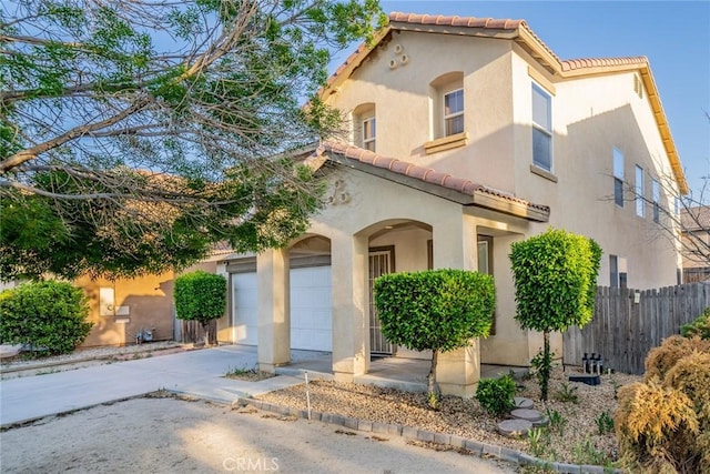 14051 Mare Ln, Victorville, CA 92394 - mediterranean / spanish-style house featuring a tile roof, driveway, a garage, and stucco siding